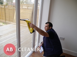 Professional AB Cleaner During a Window Cleaning
