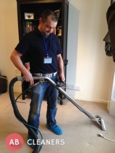 AB Cleaner Vacuuming a Carpet